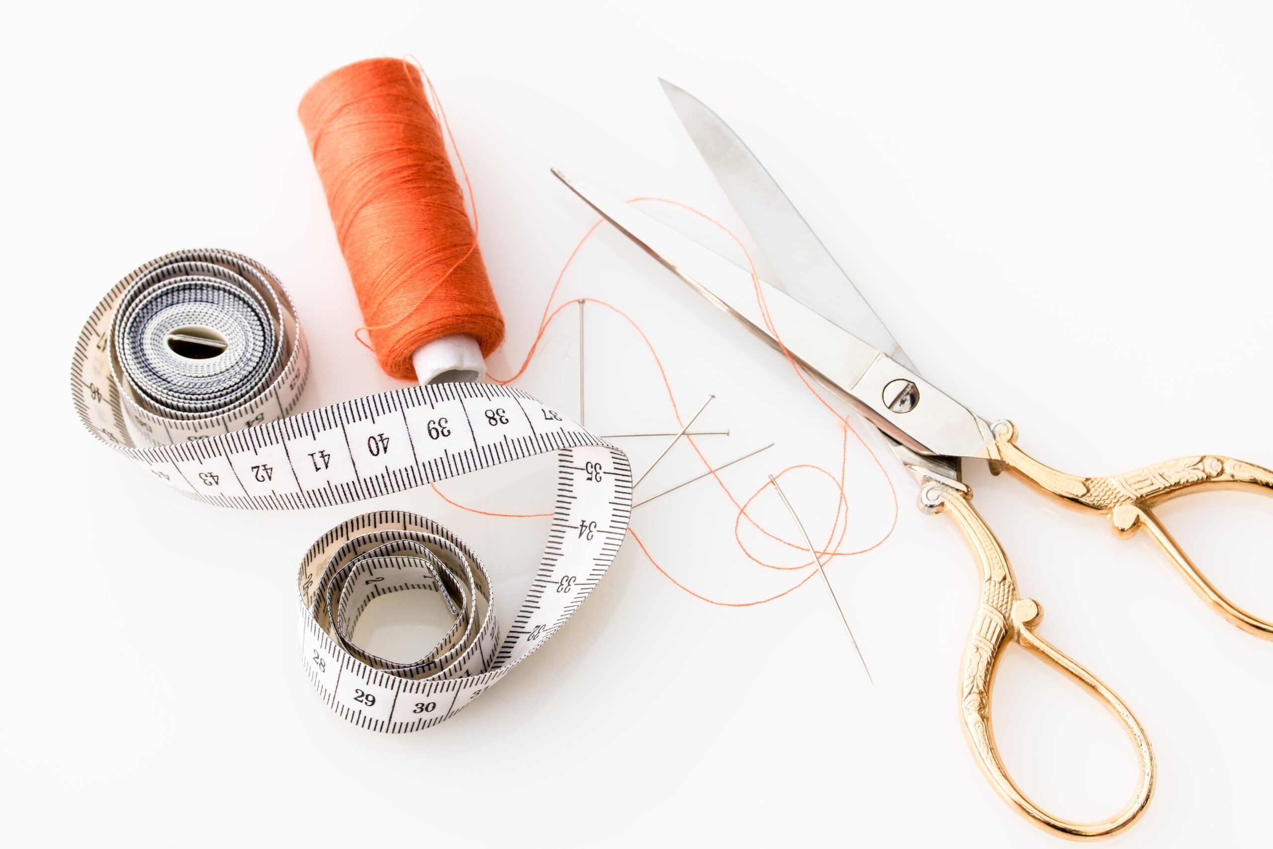 measuring tape, thread, and scissors